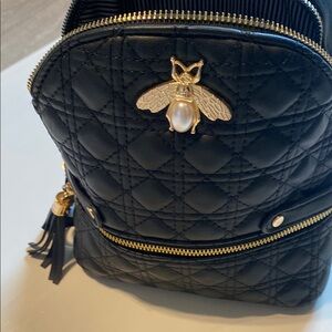 Elegant Black Quilted Backpack with Gold Accents